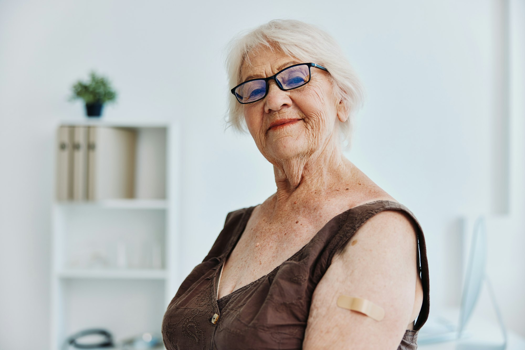 elderly woman in hospital covid passport immunization safety